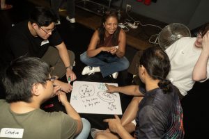 Corporate Team Building for Utopia Rising showing participants engaged in the Improv Workshop by Pamela Pilawa in Sydney