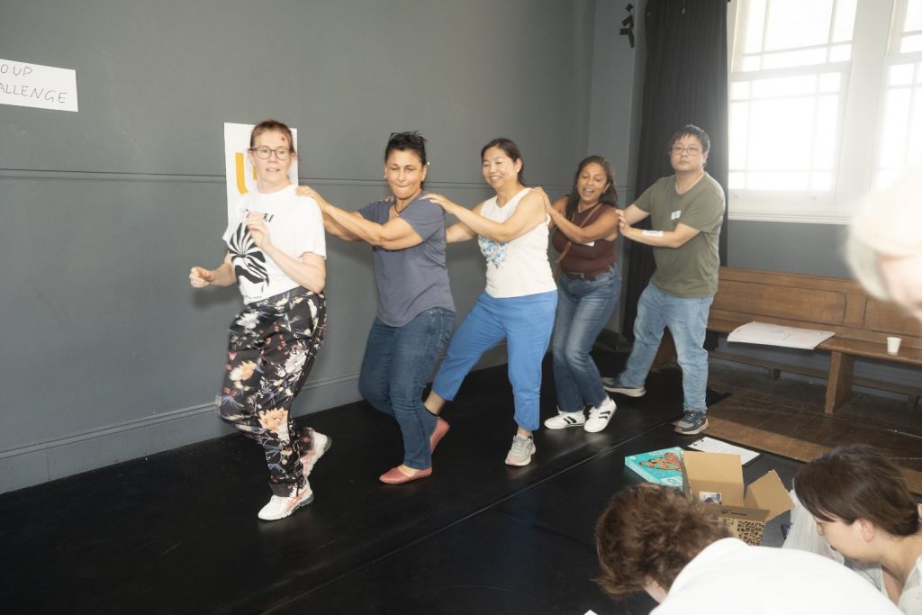 Corporate Team Building for Utopia Rising showing participants engaged in the Improv Workshop by Pamela Pilawa in Sydney