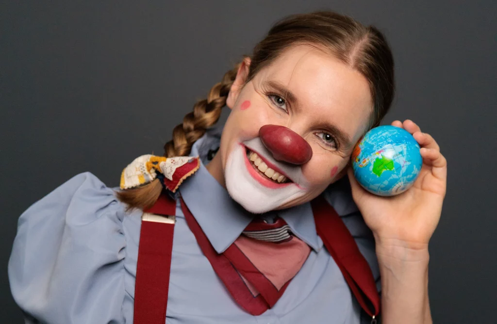 Multilingual Actress Pamela Pilawa posing with a glob of the world